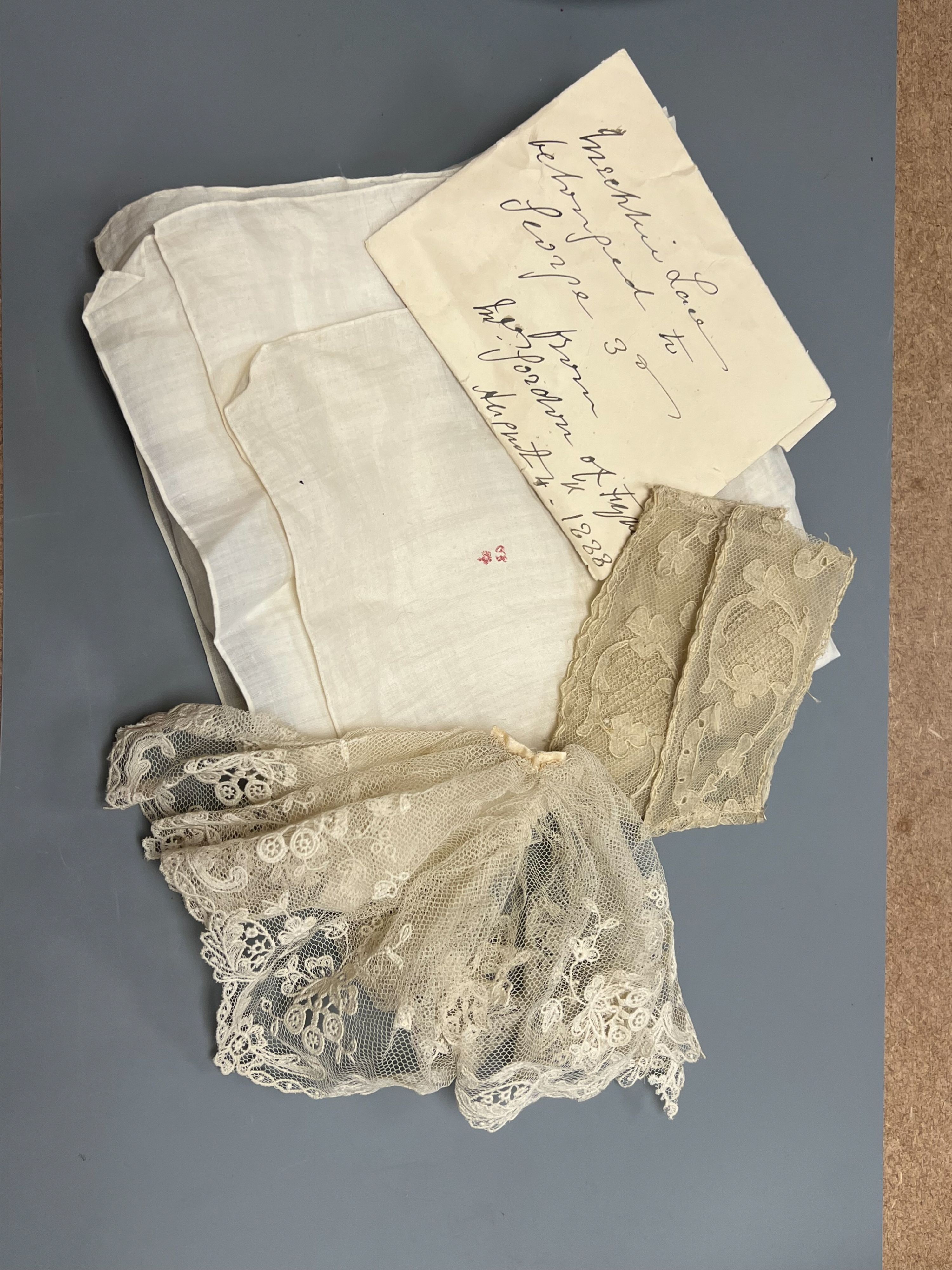 A George III handkerchief with George III cypher and three pieces of lace (4)